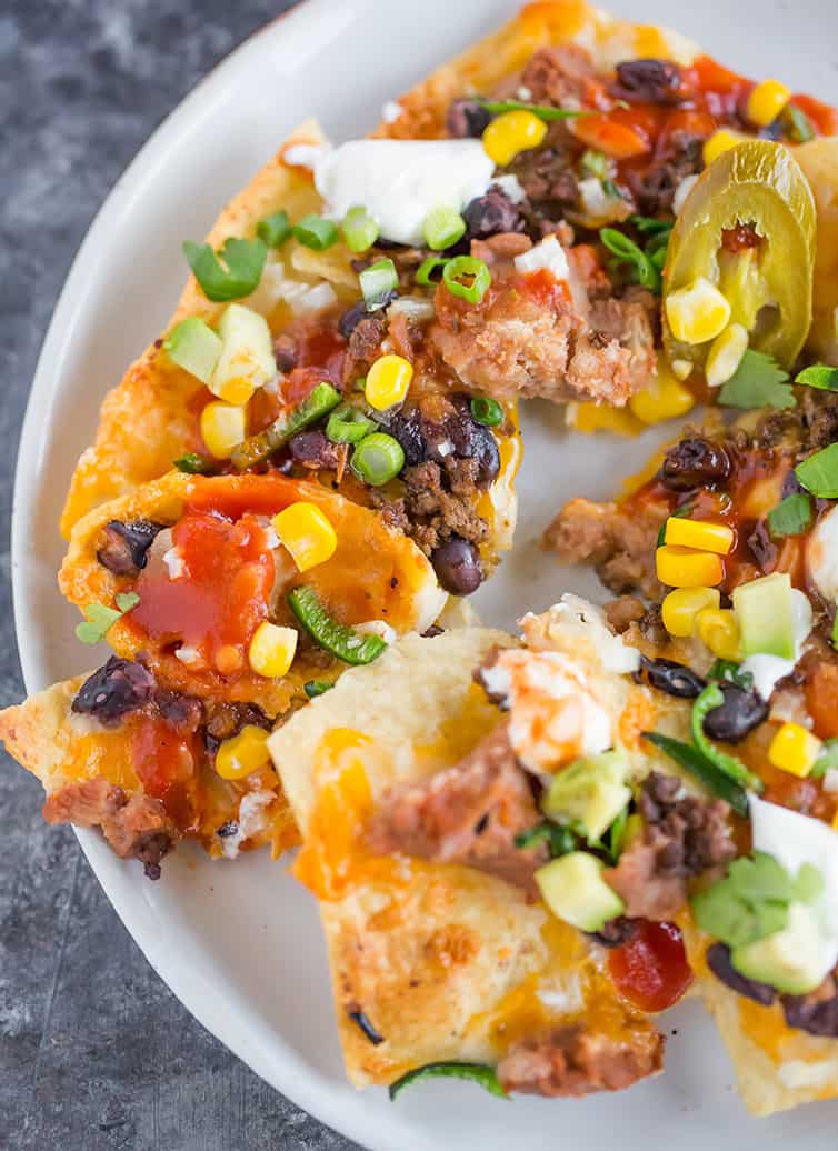 A plate full of loaded nachos.