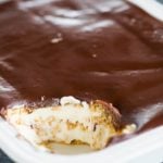 A pan of Chocolate Eclair Cake with a scoop taken out of the corner.