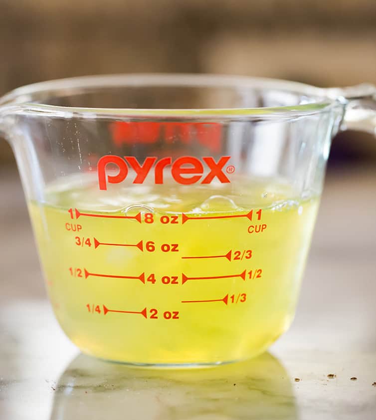 A measuring cup with egg whites measuring 1 cup.