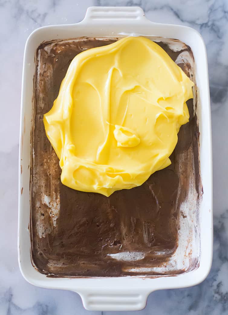 French vanilla pudding being spread over chocolate pudding.