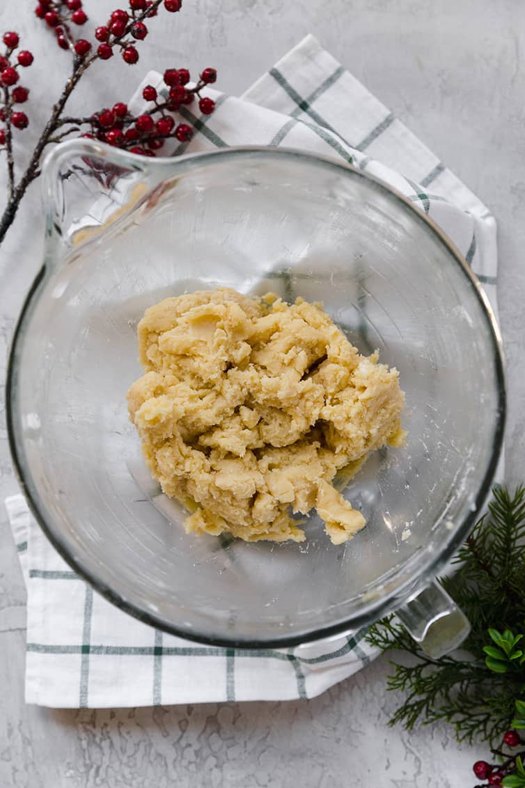 A glass mixing bowl with the dough for Danish butter cookies.