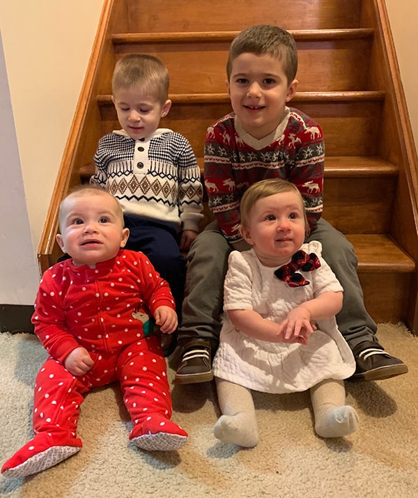 Four kids sitting on steps.