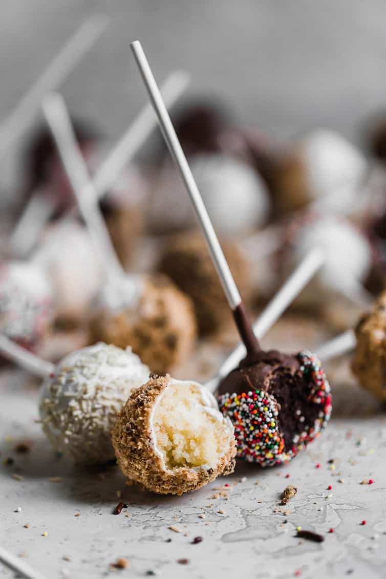 Vanilla and chocolate cake pops with bites taken out.