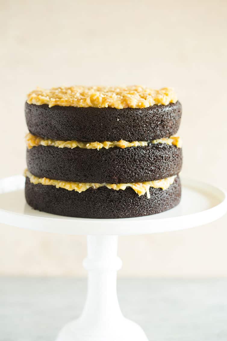 Three layers on chocolate cake filled with coconut-pecan frosting.