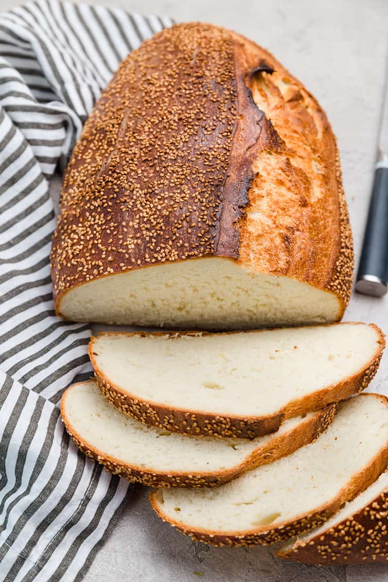 An overhead photo of a loaf of Italian bread, sliced.