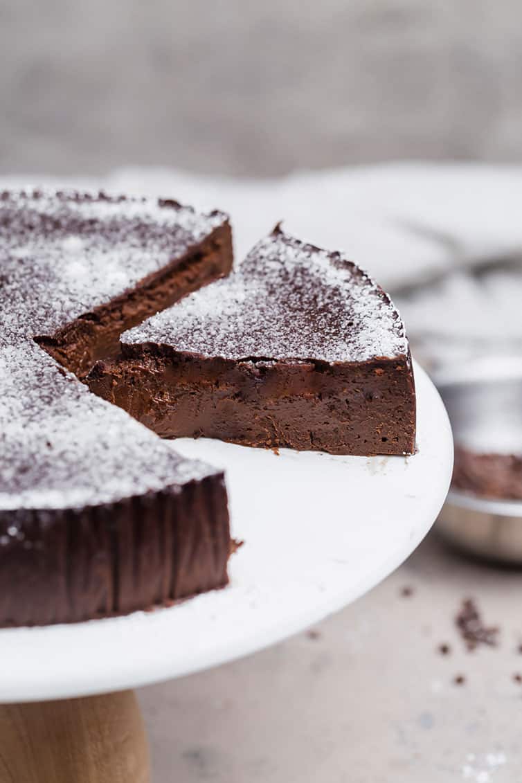 A slice of chocolate cake cut away from the whole cake.