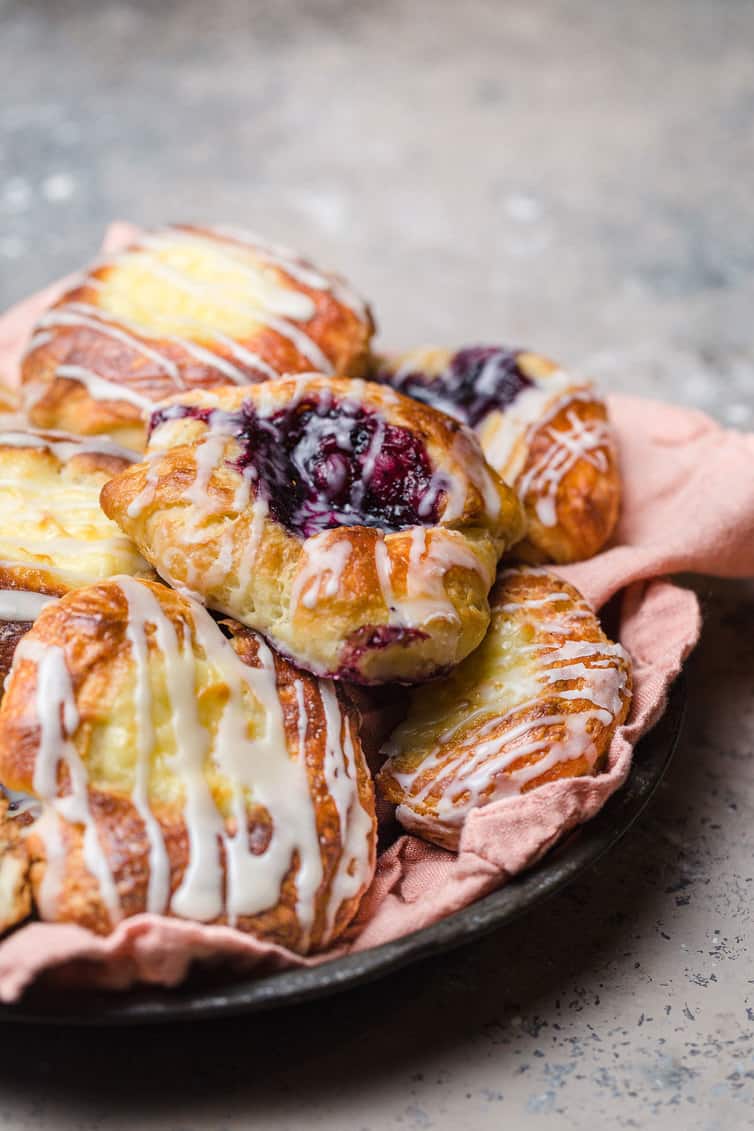 A plate of cheese and fruit Danish pastries.