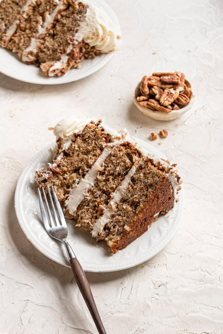 A slice of hummingbird cake on a plate with a fork.