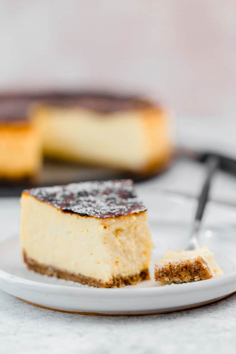 Slice of cheesecake on a plate with a fork.