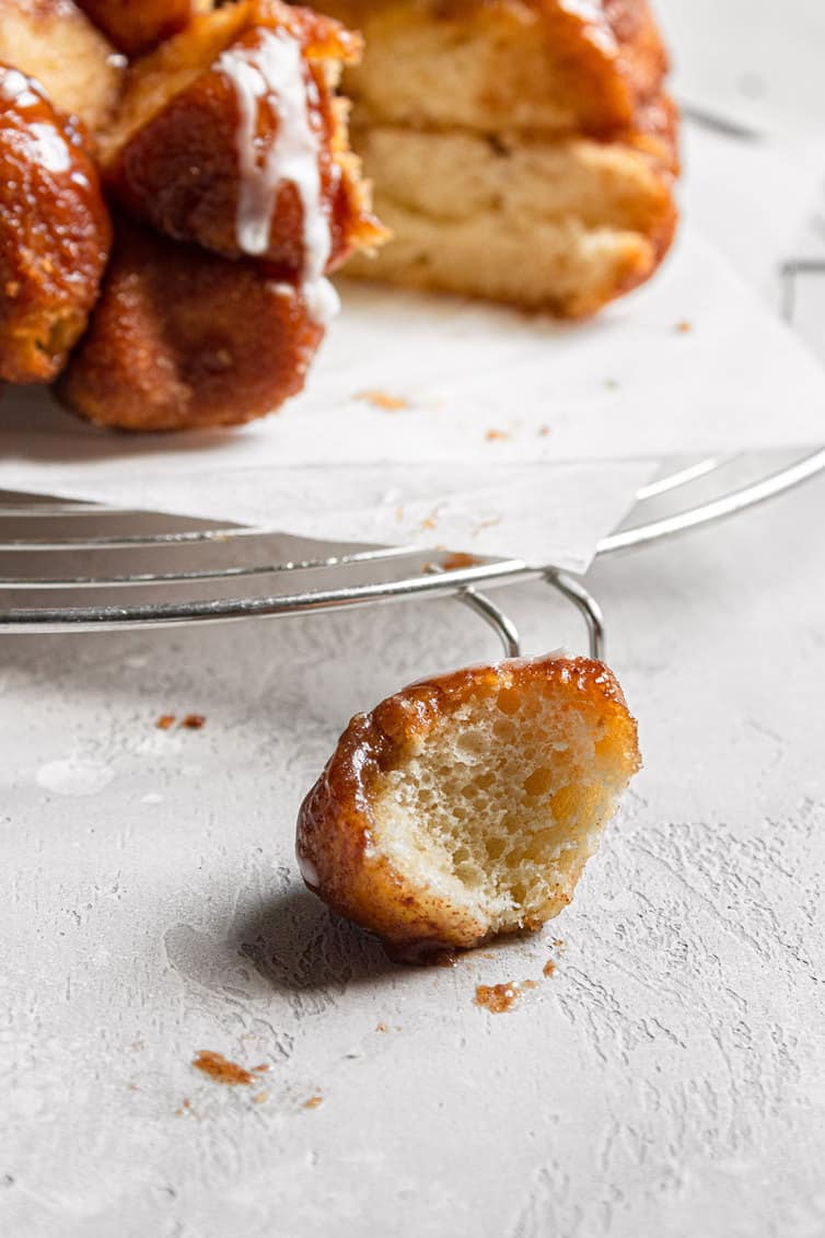 Ball of cooked monkey bread bitten into so you can see the inside.