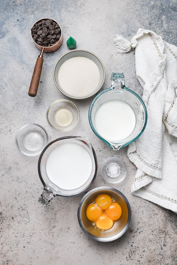 Ingredients for mint chocolate chip ice cream prepped in bowls.