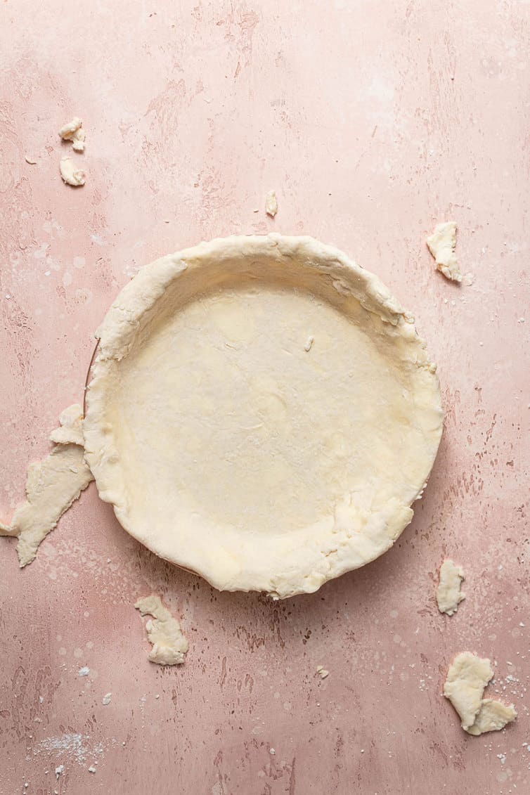 Pie crust fitted into a pie plate.