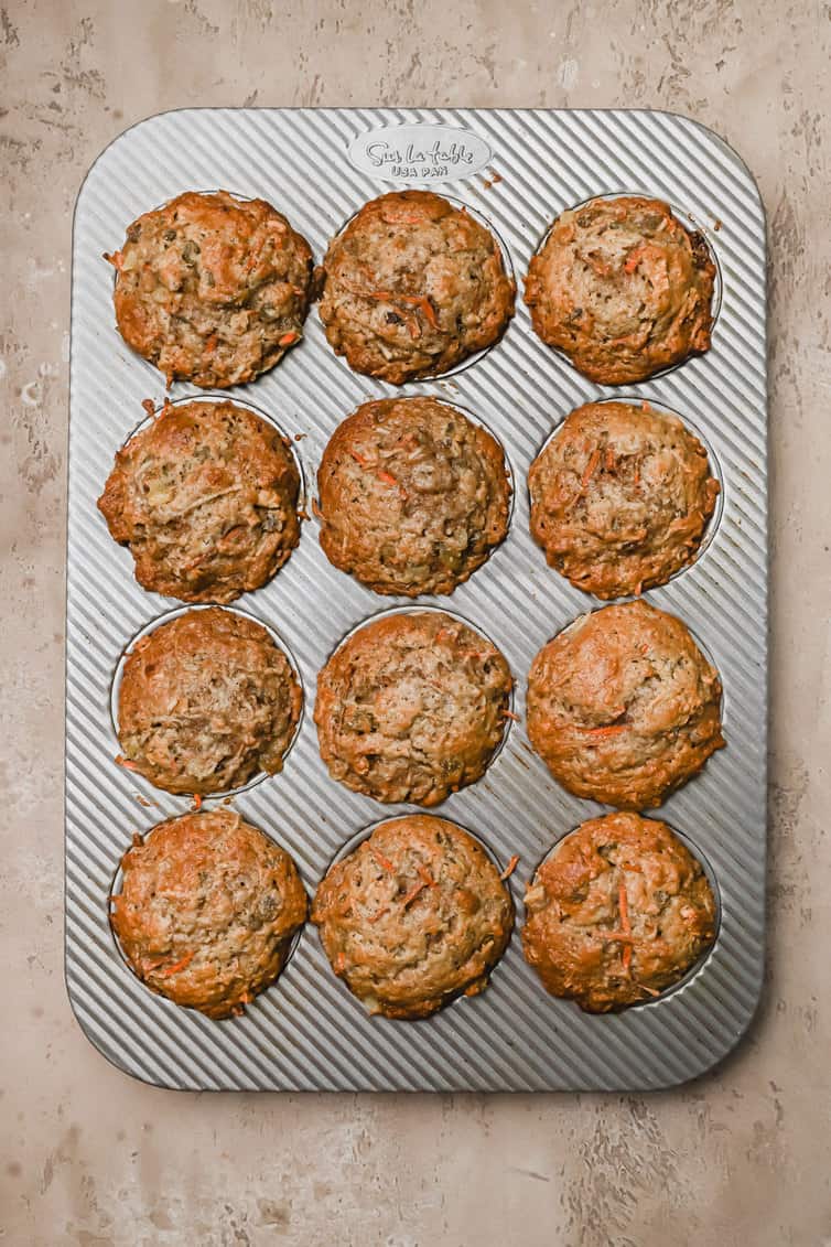 Overhead photo of baked morning glory muffins in muffin pan.