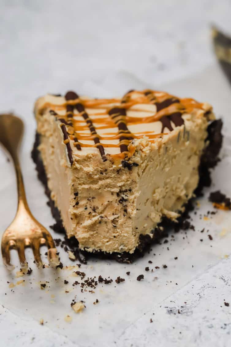 A slice of peanut butter pie with a bite taken out of it.