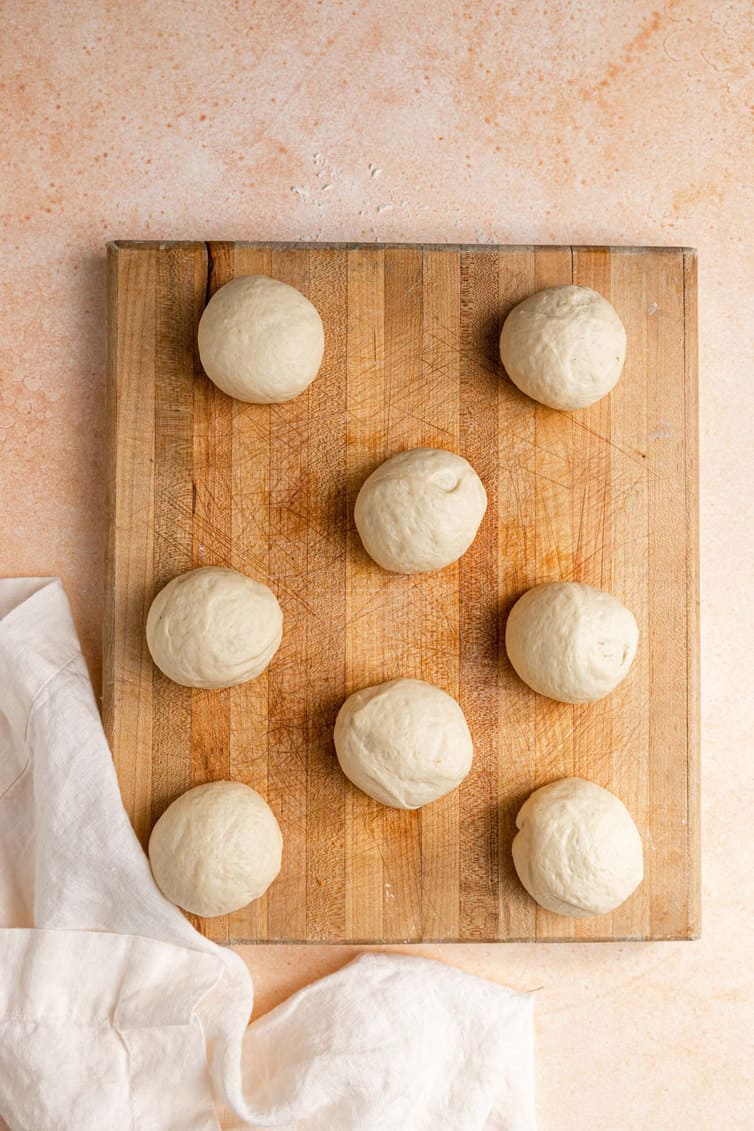 Balls of dough on a wooden board.