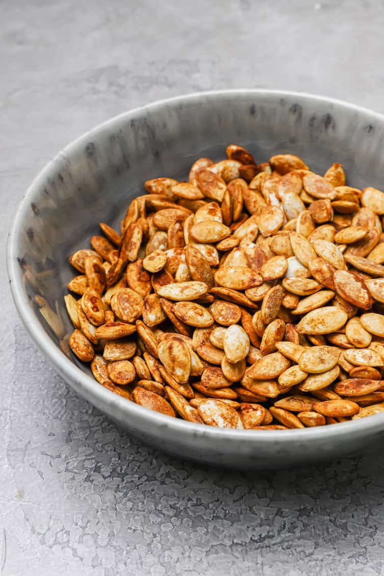 A bowl of roasted pumpkin seeds.