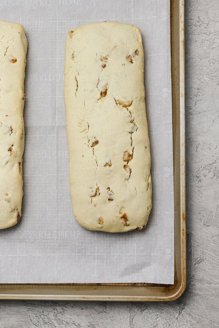 Logs of biscotti baked on baking sheet.