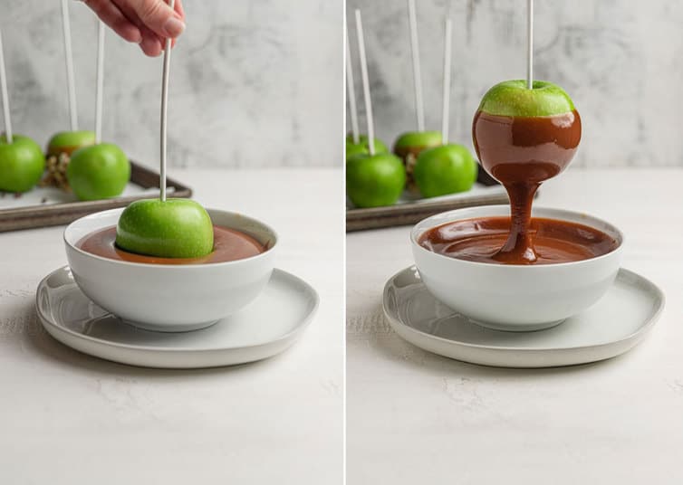 Granny Smith apple being dipped in a bowl of caramel.