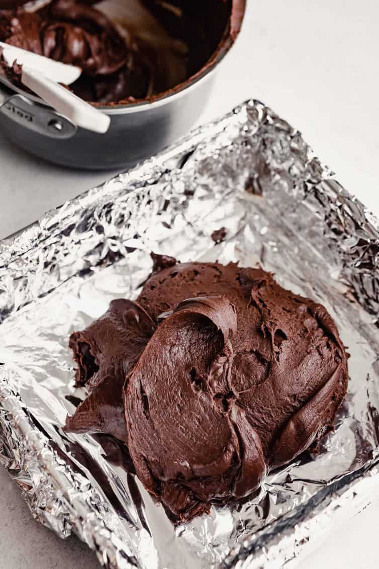 Chocolate fudge mixture in foil-lined pan.