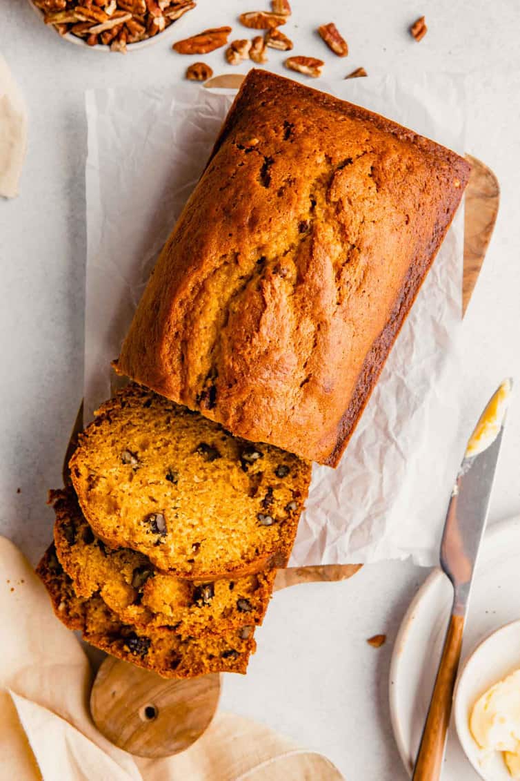 Overhead photo of pumpkin bread loaf with some pieces sliced.