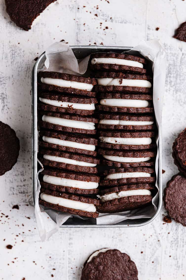 Homemade Oreo cookies stacked in a tin.