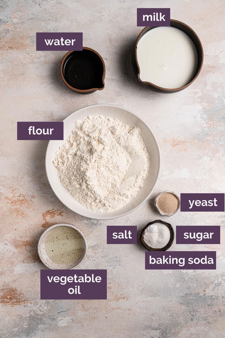 The ingredients of english muffin bread in bowls and plates.