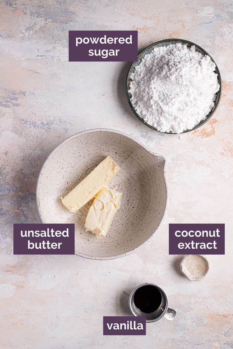 Ingredients for coconut frosting on the counter in bowls labeled with purple labels.