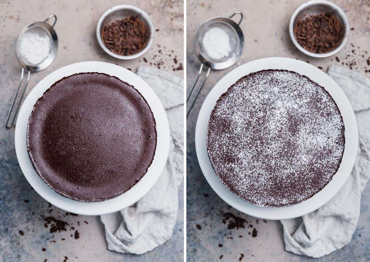 Flourless chocolate cake on a cake plate dusted with powdered sugar.