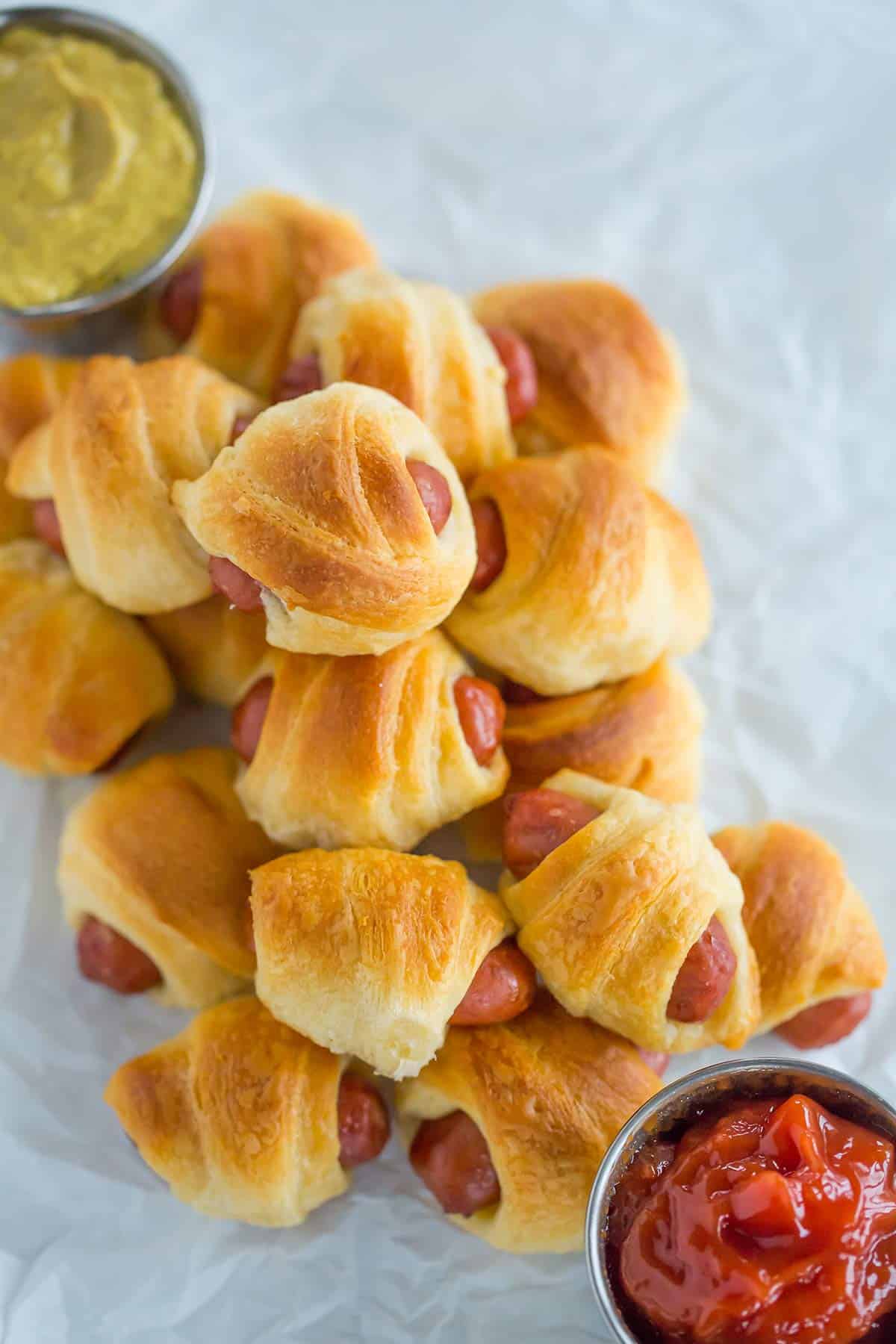 An overhead shot of mini hot dogs wrapped in crescent roll dough.