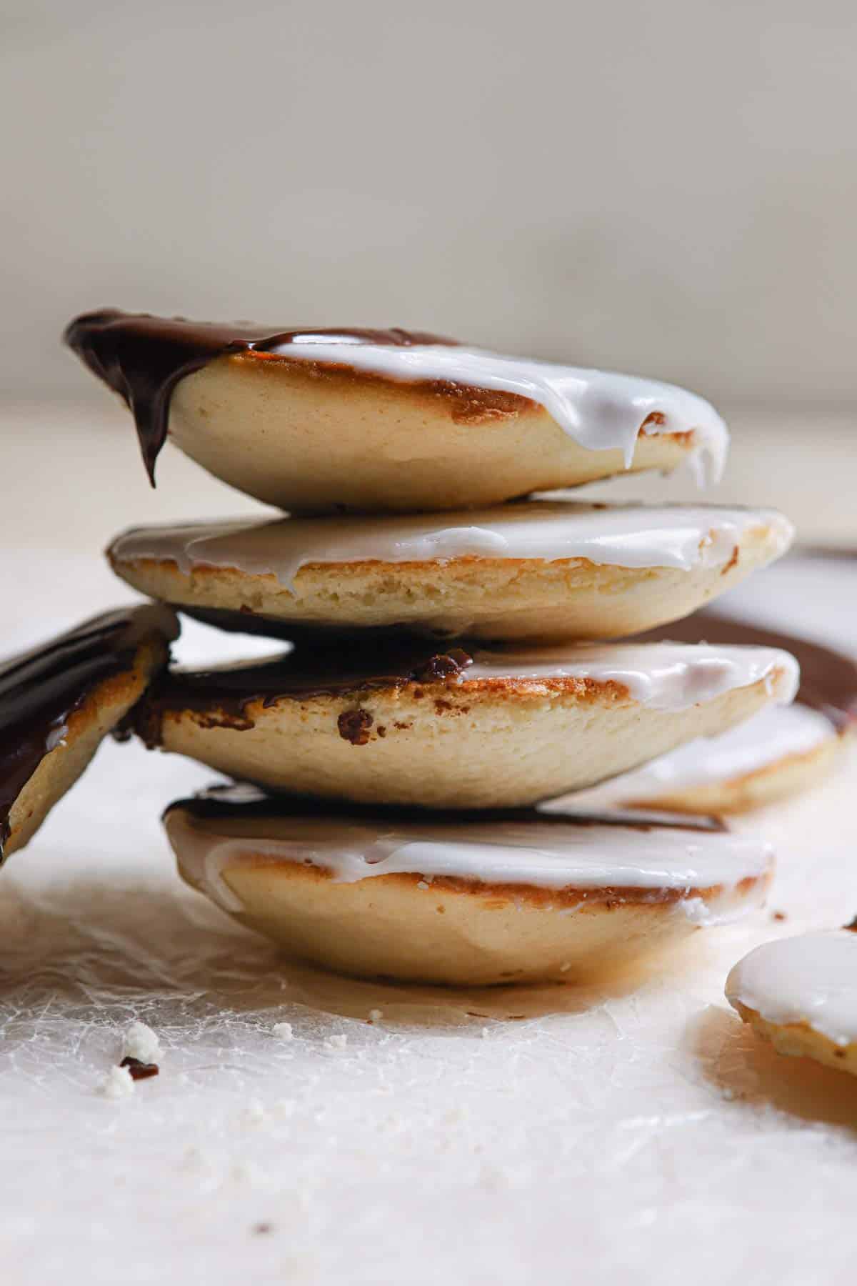 A stack of black and white cookies on a counter.