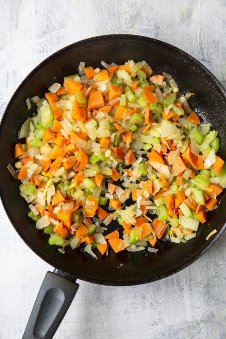 Onions, celery, and carrots in skillet