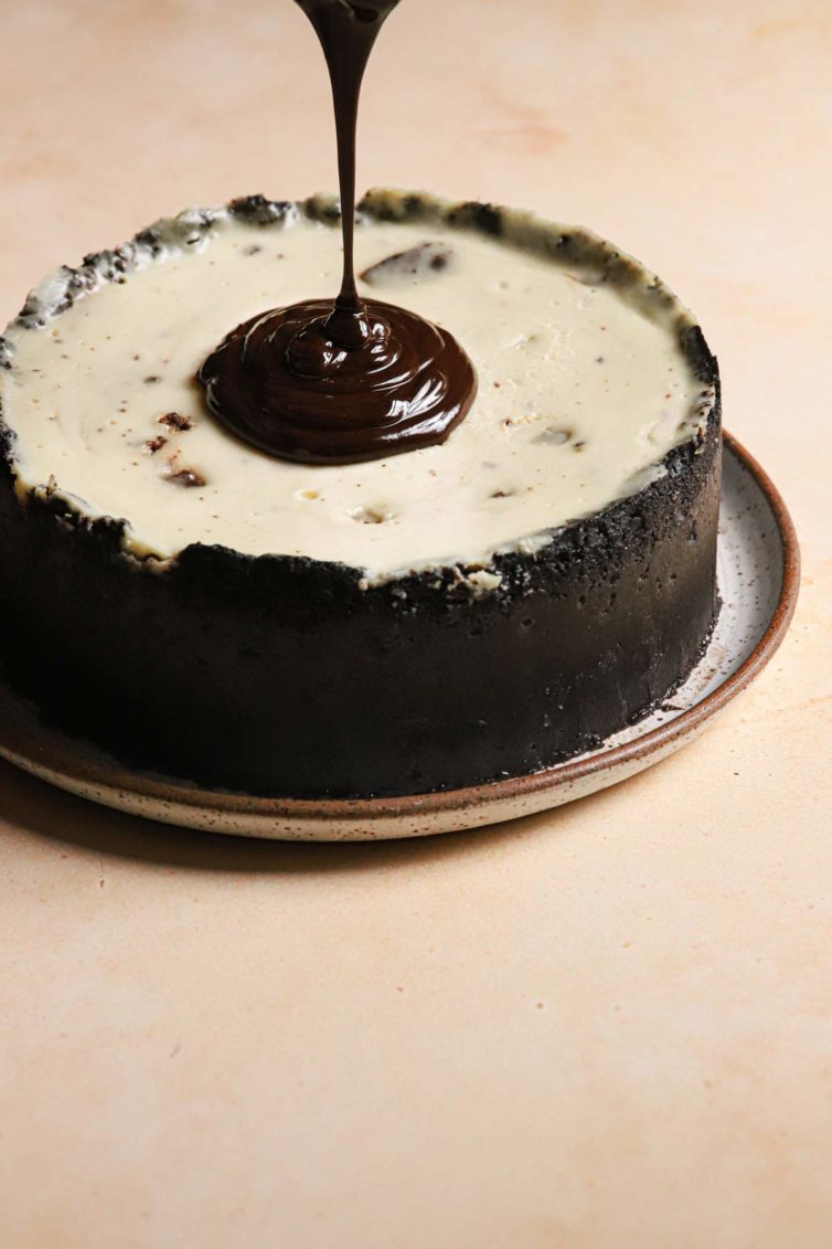 topping this brownie cheesecake with the smooth chocolate ganache