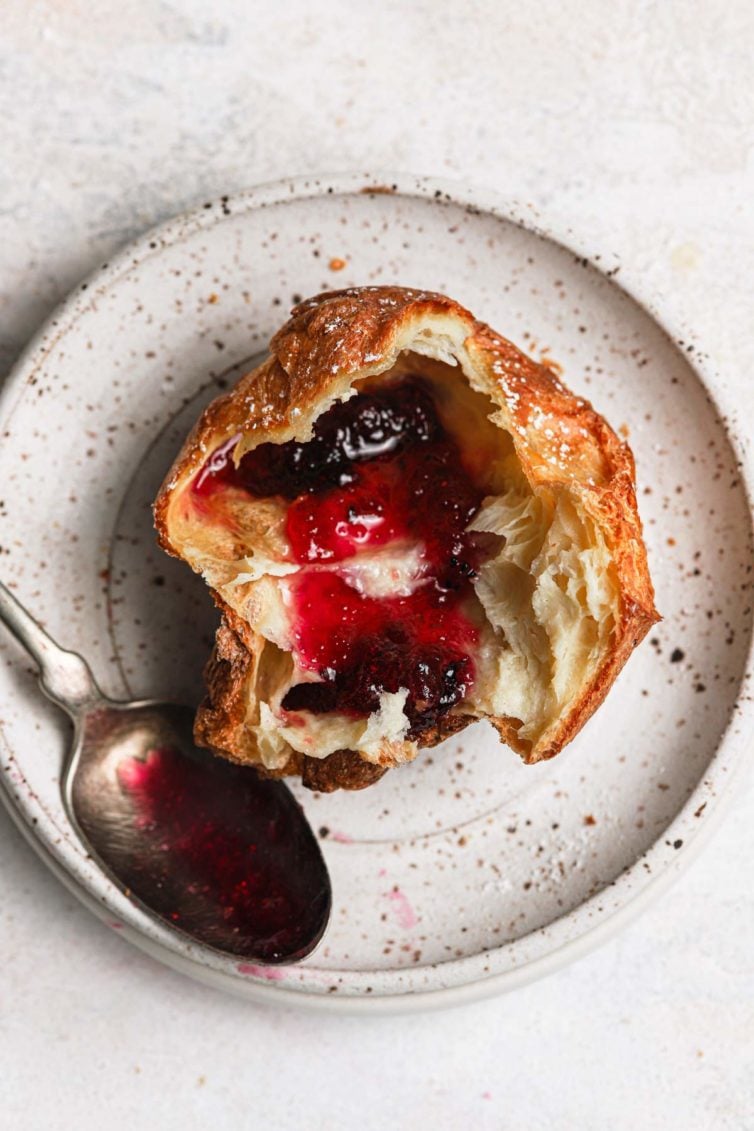 Easy popovers sliced in half and served with butter and strawberry jelly