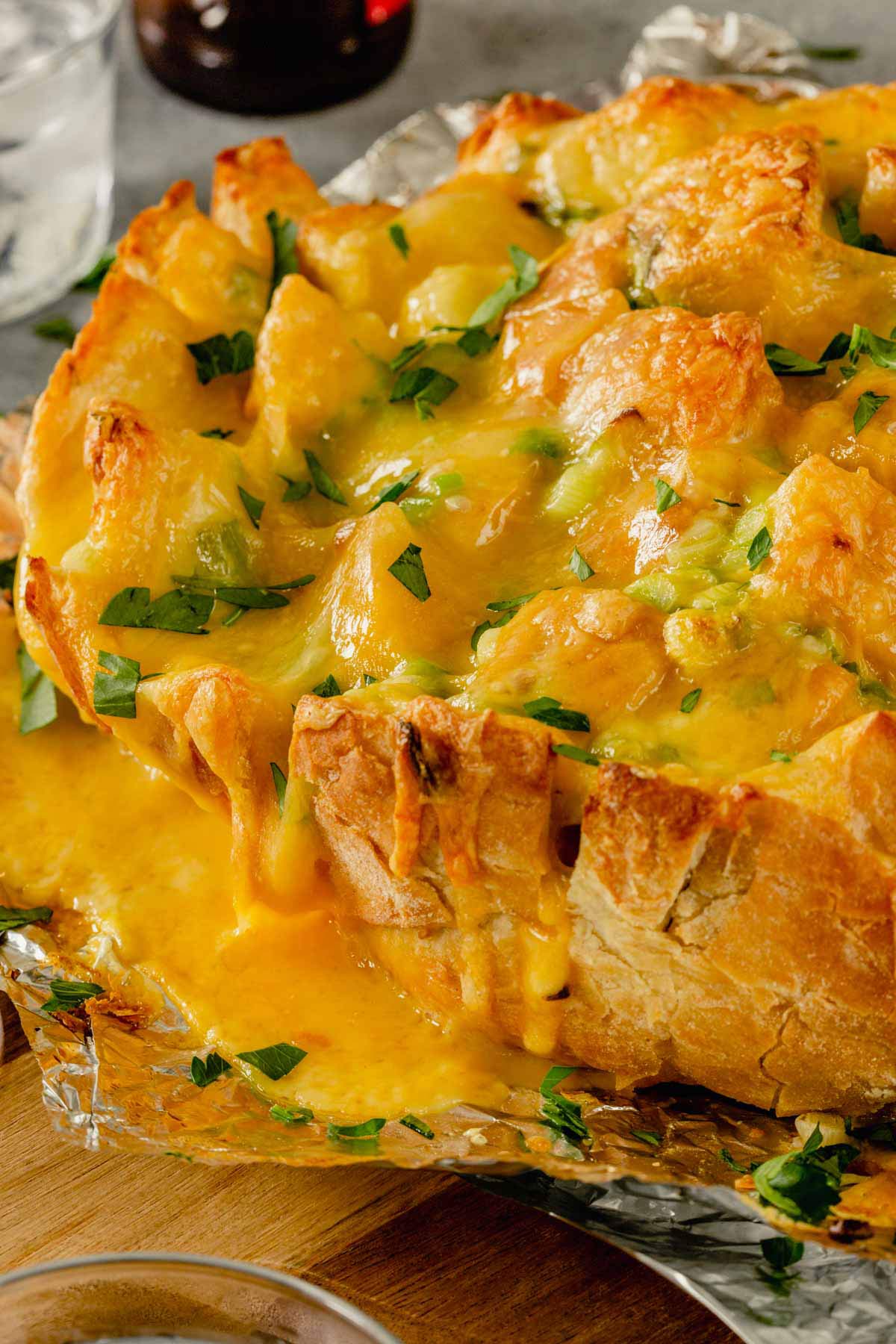 Side view of pull-apart bread with melted cheese on the side.