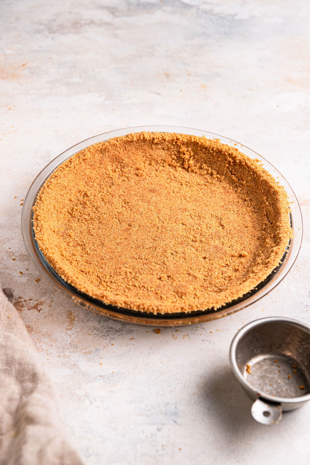 Graham cracker crust pressed into a glass pie plate.