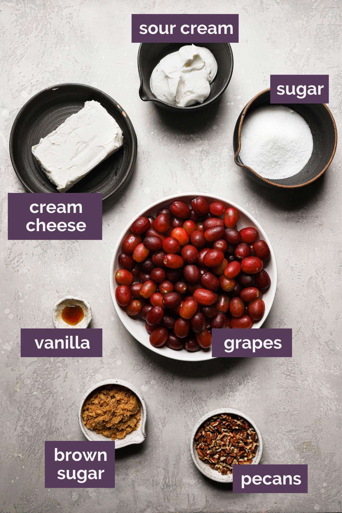 an overhead and labeled view of the ingredients needed to make this easy grape salad recipe 