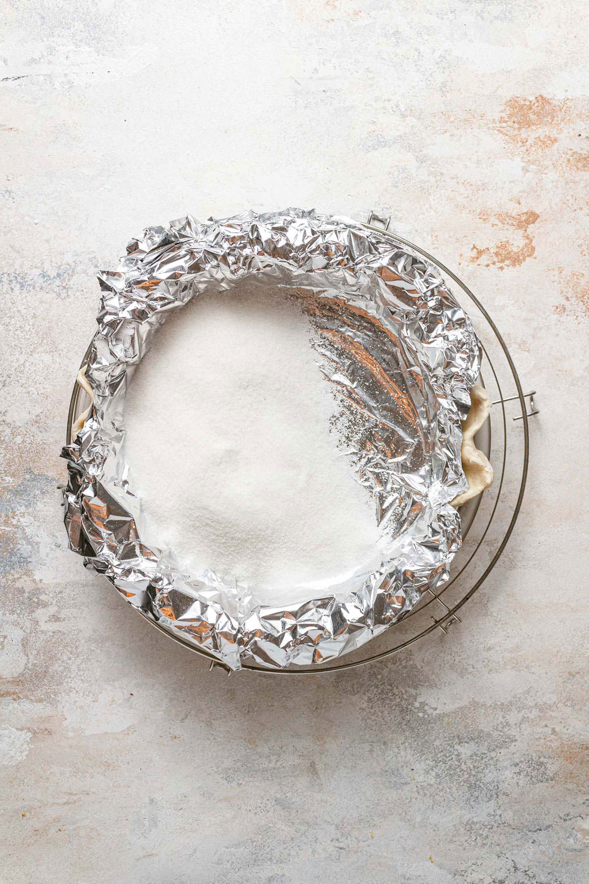 Blind baking a pie crust covered in foil.