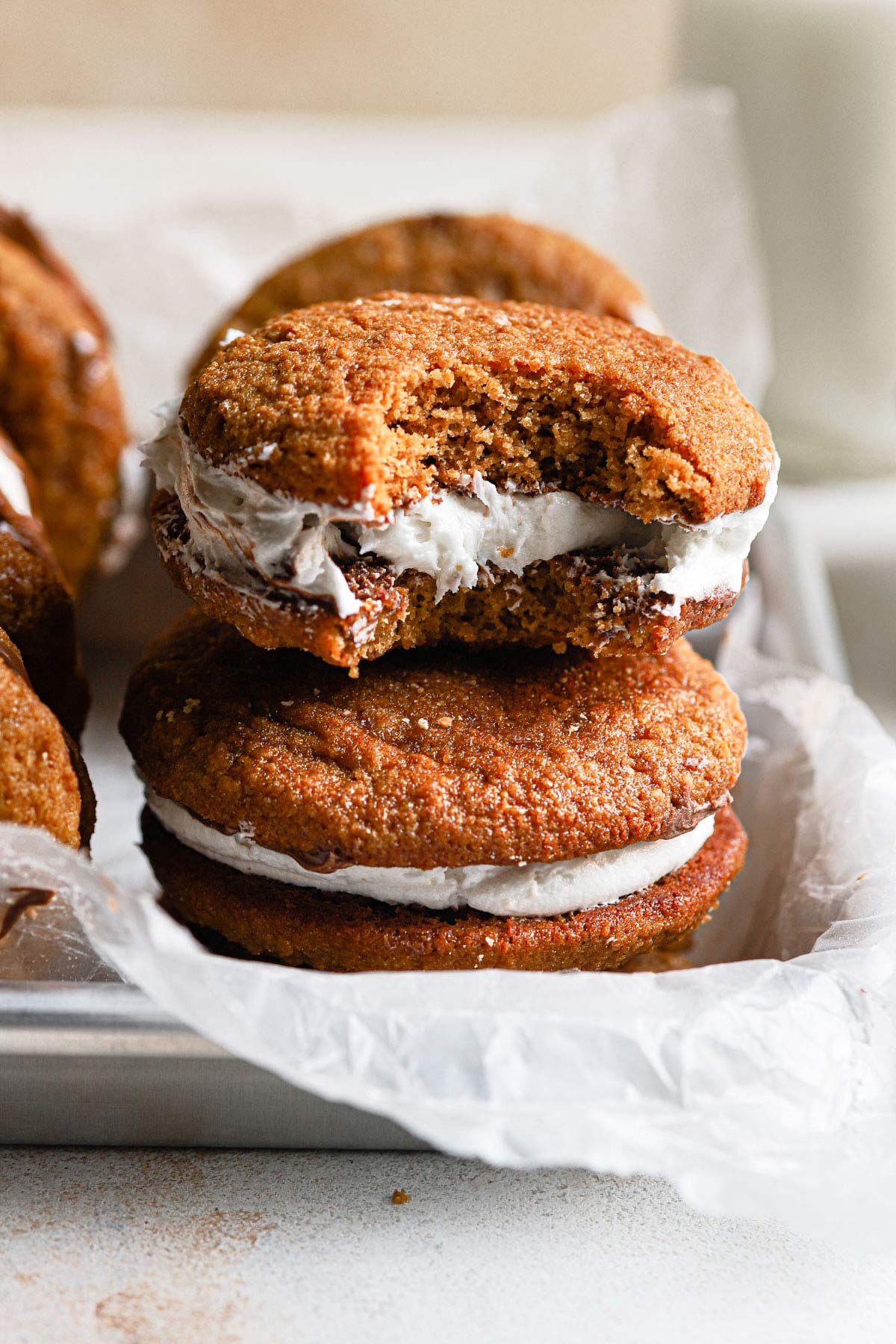 A closeup photo of s'mores whoopie pie with large bite taken out of it.