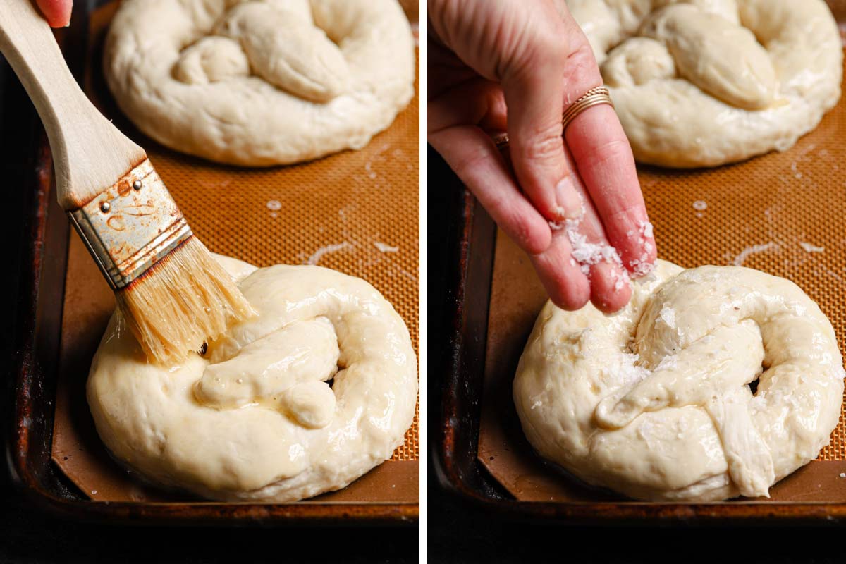 The author brushes the pretzel dough that just came out of the water bath with an egg wash and sprinkles with the coarse salt before baking