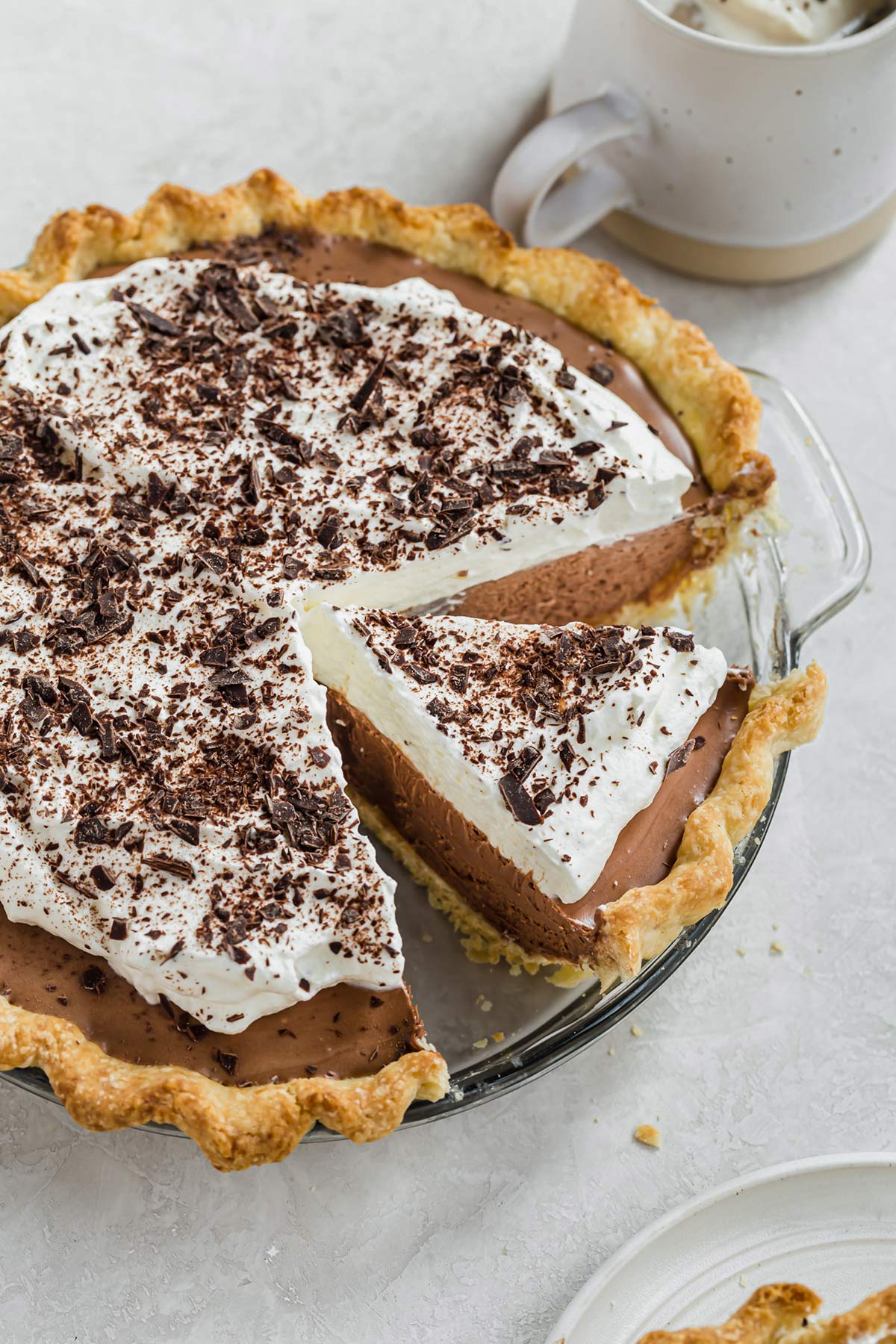 An overhead photo of French silk pie topped with whipped cream and chocolate curls.