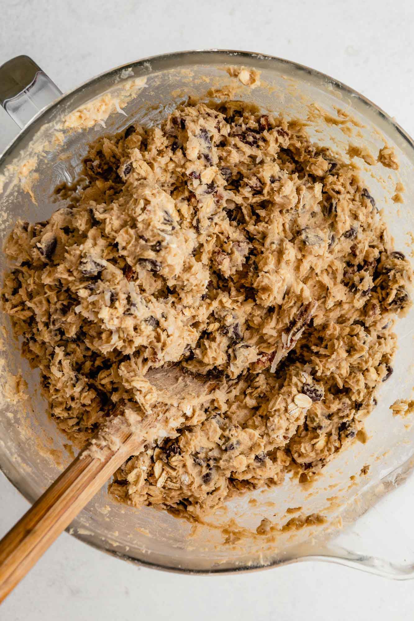 Cowboy cookie dough in a glass mixing bowl.