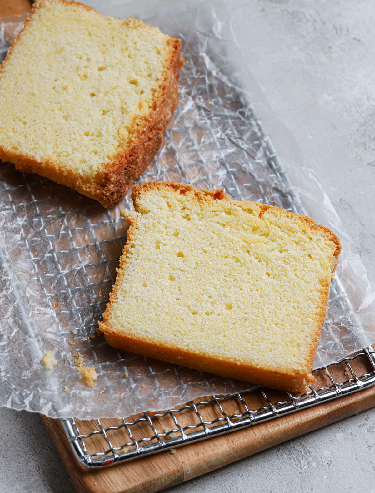 Slices of pound cake on a wax paper-lined cooling rack.