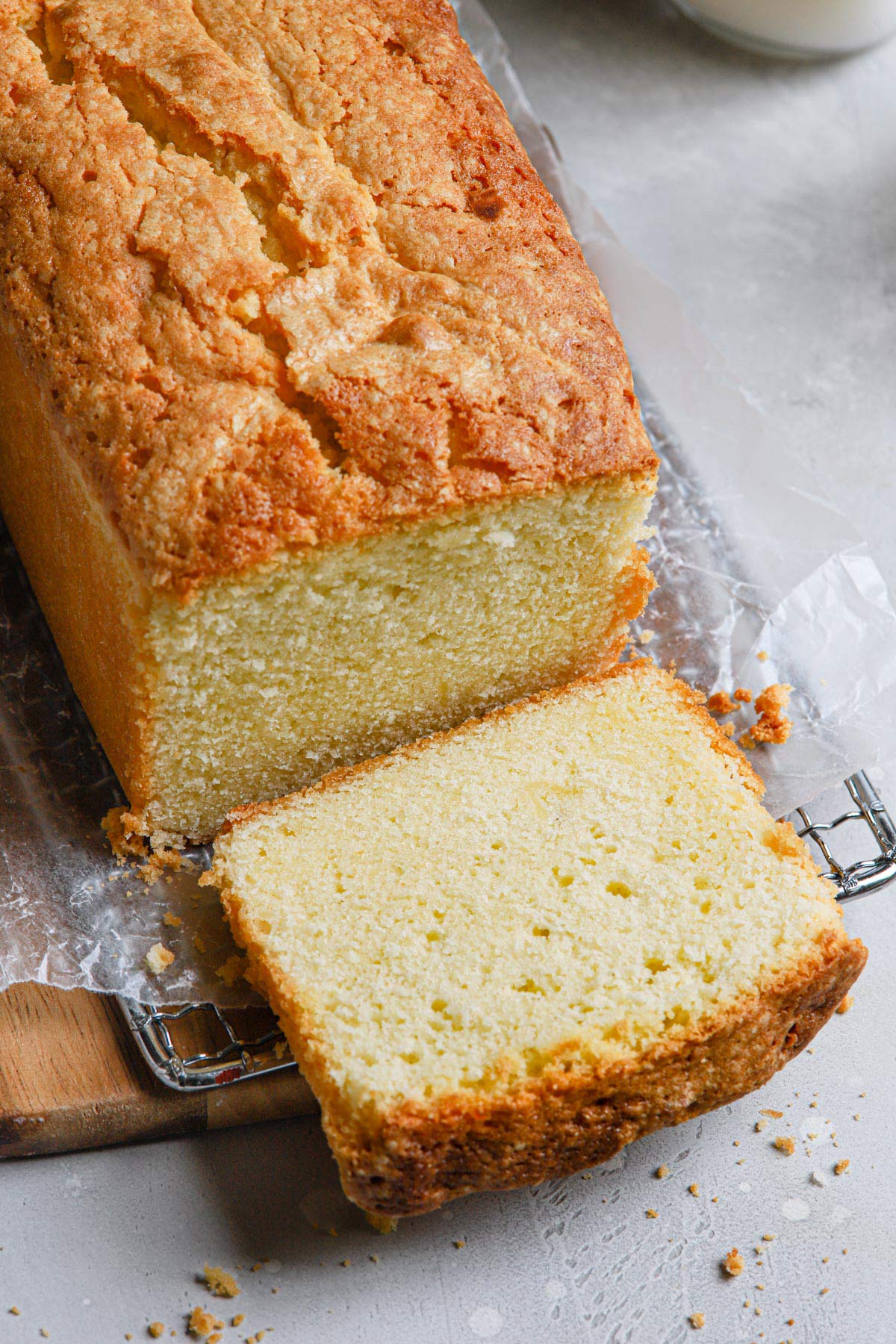 Loaf of buttery pound cake with a piece sliced off.