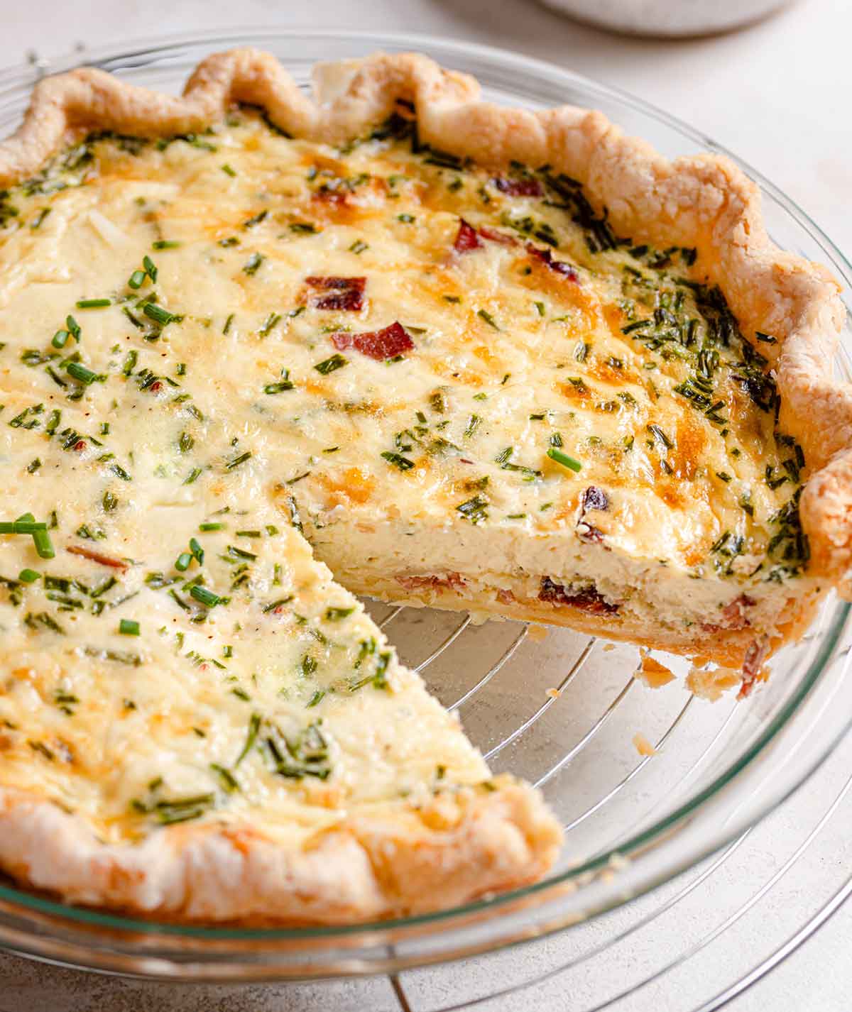 Baked quiche with a slice removed from the pan.