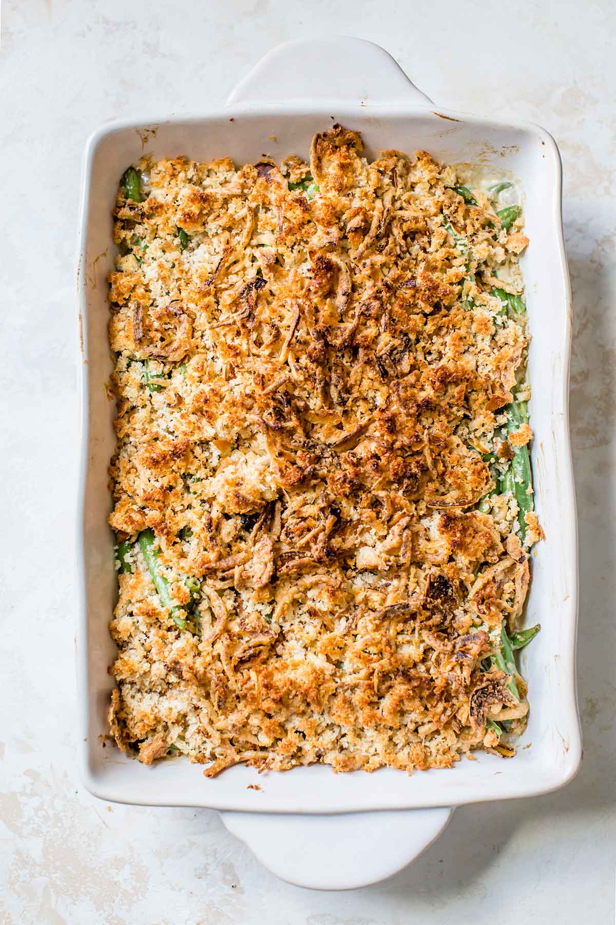 Overhead photo of green bean casserole in baking dish, right after coming out of the oven.