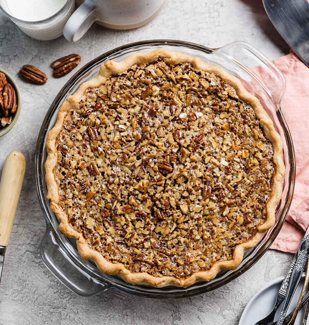 Overhead photo of baked pecan pie in a glass pie plate.