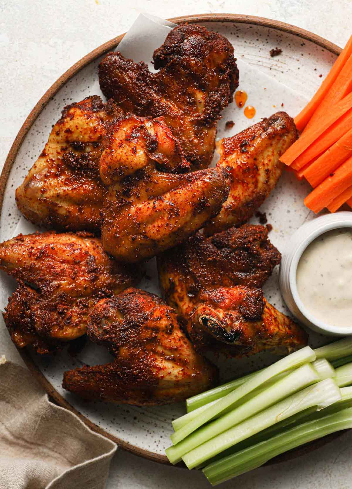 Platter of chicken wings with carrots, celery sticks, and ranch dressing.