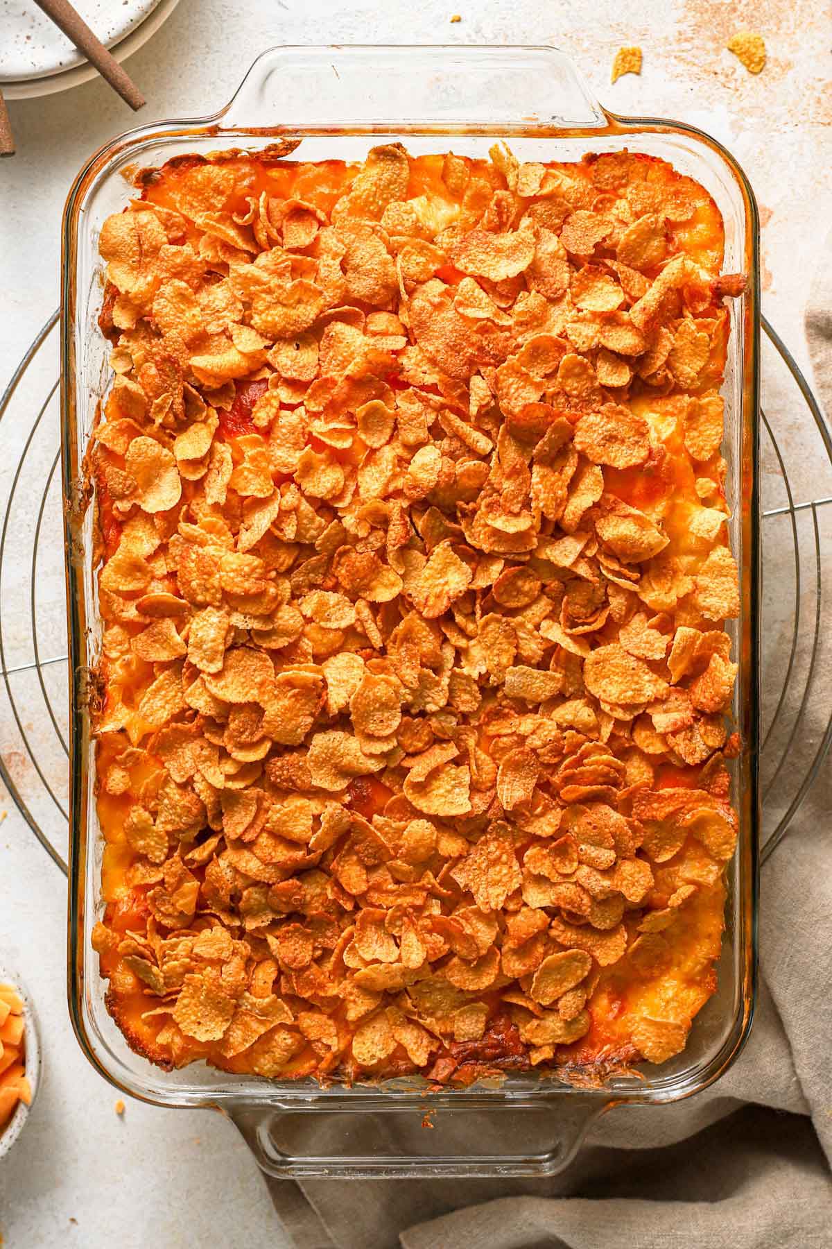 Overhead photo of baked cheesy potato casserole in a glass baking dish.