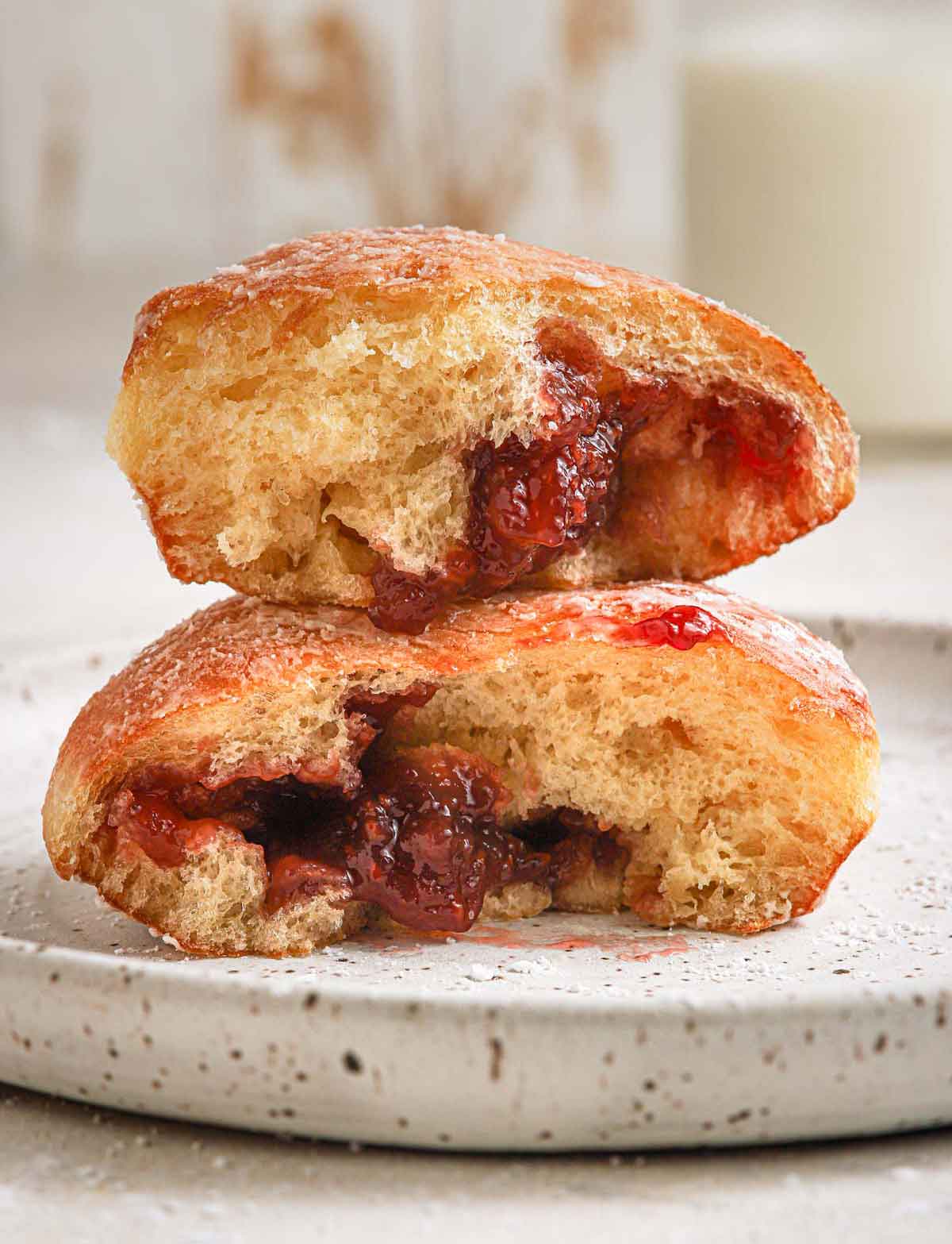 Paczki doughnut broken in half and stacked on top of each other.